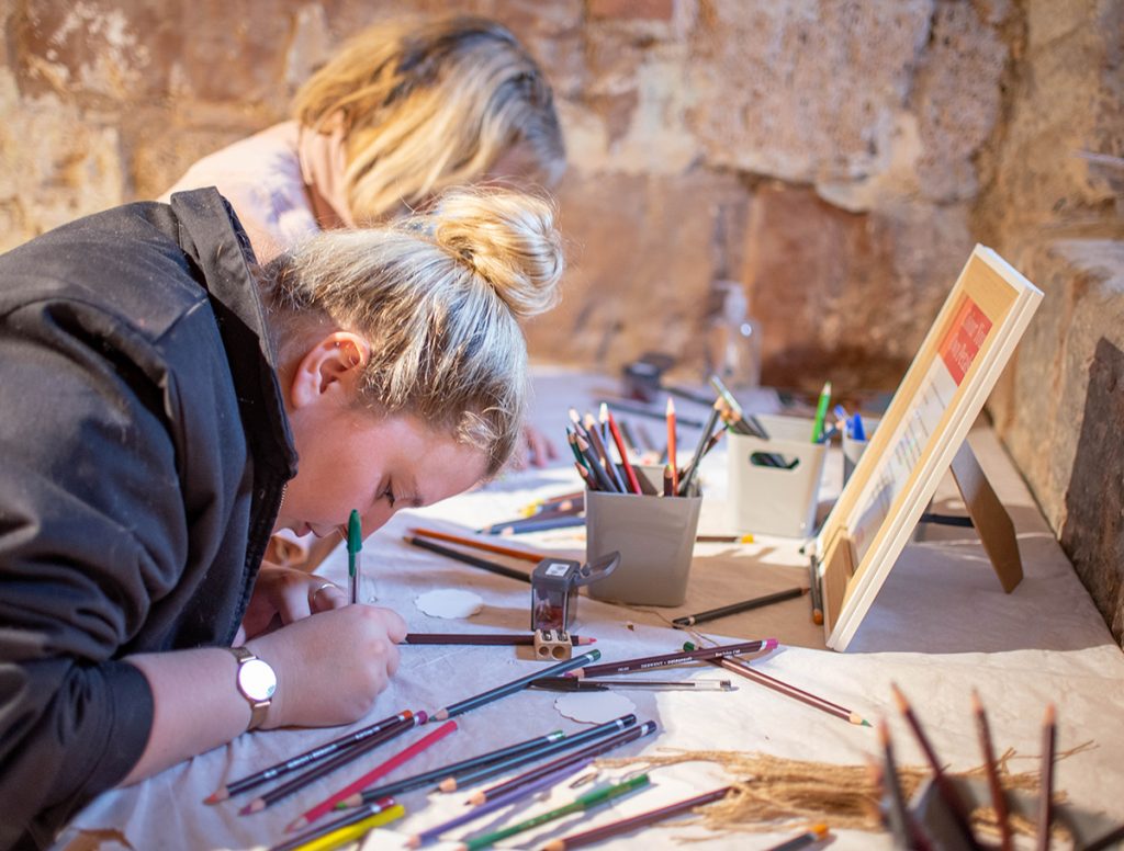 two women colouring with Derwent pencils